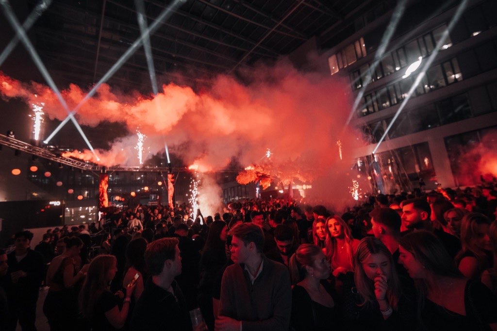 Red smoke and white lasers above the crowd